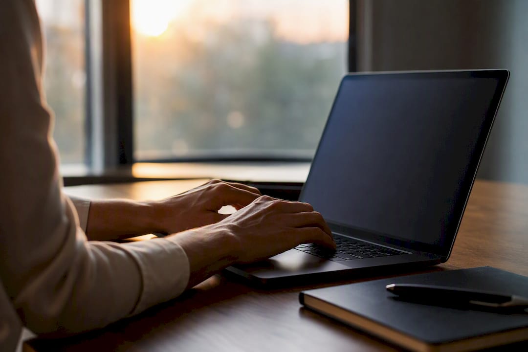 Hands typing on keyboard in office