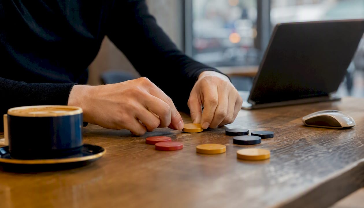 Hands placing risk-level tokens on surface